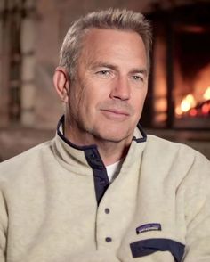 a man sitting in front of a fire place