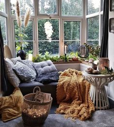 a living room filled with lots of windows and furniture next to a window sill