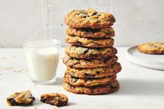 a stack of cookies next to a glass of milk