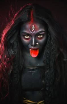 a woman with black makeup and red eyes