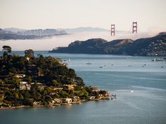 the golden gate bridge in san francisco is seen from across the bay on a foggy day