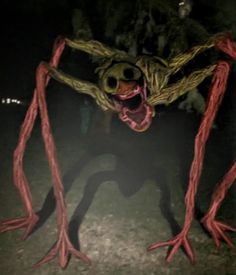 a creepy looking creature standing in the dark