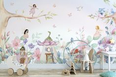 a child's room decorated in pink and green with fairy themed wallpapers