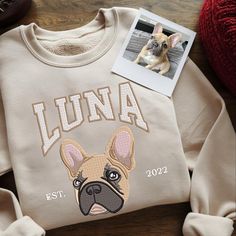 a sweater with an image of a dog on it and the name lunaa printed on it