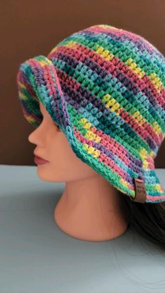 a crocheted hat is on top of a mannequin's head