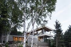 the house is surrounded by trees and rocks