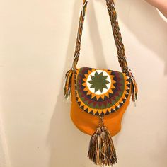 an orange purse is hanging on the wall