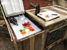 an outdoor cooler with food and drinks in it