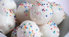 white cake truffles with sprinkles in a bowl on a table