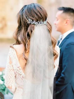 a bride and groom standing next to each other