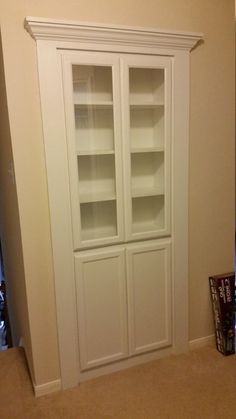 a white bookcase sitting in the corner of a room