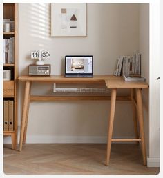 a wooden desk with a laptop on top of it next to a bookshelf