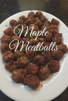 a white plate topped with meatballs on top of a table