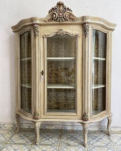 an old fashioned china cabinet with glass doors