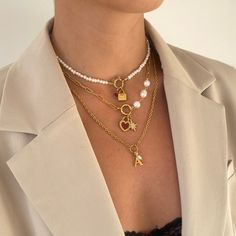 Our Allegra Necklace features a textured cable chain with O-ring to center with initial and mini freshwater pearl charms. Elegantly designed, this necklace makes a special personalised gift for a loved one or addition to your own collection. 18k gold plated stainless steel + freshwater pearls Length: 18" + 2" extender (can be made shorter, please leave desired length in 'order notes' section at checkout) Tarnish and sweat resistant Hypoallergenic no green skin 1 year warranty Trendy White Pearl Chain Charm Necklace, Trendy Charm Necklace With Pearl Pendant As Gift, Trendy Metal Pearl Necklace For Gift, Trendy Pearl Pendant Charm Necklace For Gift, Trendy Gold Pearl Charm Necklaces, Trendy Gold Charm Necklace With Pearl Pendant, Trendy Pearl Chain Charm Necklaces, Trendy Pearl Necklace As A Gift, Trendy Pearl Charm Necklace Gift