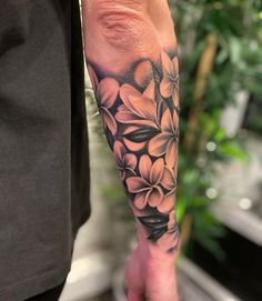 a person with a flower tattoo on their arm