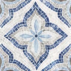 a blue and white tile wallpaper with an intricate design in the shape of a flower