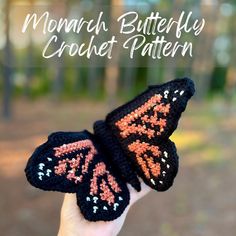 a hand holding up a crocheted butterfly with the words monarch butterfly crochet pattern on it