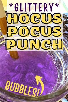 a glass bowl filled with purple liquid and the words glittery hoccus pocus punch