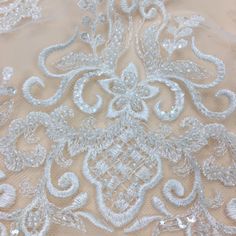 This Stunning Luxury High quality Embroidered Lace Fabric design piece has soft hand feel, ideal for use in DIY craft projects, wedding dress, clothing, party dress, dolls outfits, curtains, shams, lamp shades, headpieces, costumes, accessories, Apparel, handcraft Accessory, cake decor, unity candle, garters, headbands, dance costumes, belly dance costumes. --- THE DETAILS --- 801 This listing is for 1 yard embroidery lace fabric. Wide: about 51inch/130cm Colors: off-white Material: Polyester -- White Pearl Embroidered Fabric For Mother Of The Bride, Cream Embroidered Fabric For Wedding, Elegant Wedding Fabric With Intricate Embroidery, Elegant Wedding Fabrics With Intricate Embroidery, Cream Sequin Fabric With Intricate Embroidery For Wedding, Elegant 3d Embroidered Lace For Wedding, Wedding Embellished Lace Embroidered Fabric, Elegant White Fabric With 3d Embroidery, Elegant White Embroidered Fabric With 3d Embroidery