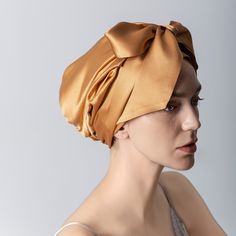 a woman wearing a head scarf on top of her head