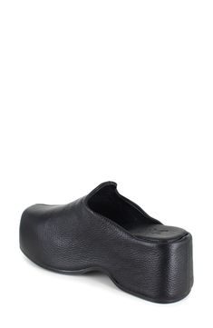 A center seam splits the streamlined silhouette of this contemporary-chic leather clog lofted on a chunky platform. 2 3/4" heel; 1 1/2" platform Water-resistant Leather upper and lining/rubber sole Made in Italy Modern Black Platform Slippers With Textured Sole, Leather Platform Slippers With Round Toe, Modern Synthetic Clogs With Textured Sole, Leather Clogs With Removable Insole And Almond Toe, Modern Slip-on Clogs With Rubber Sole, Modern Slip-on Clogs With Reinforced Heel, Leather Slip-on Mules With Reinforced Heel, Modern Leather Mules With Round Toe, Modern Clogs With Rubber Sole And Round Toe