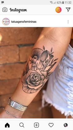 a woman's arm with a black and white rose tattoo on the left forearm