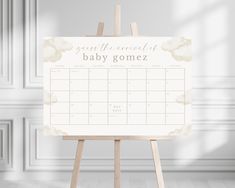 a wooden easer with a baby's name and clouds on the side, in front of a white wall