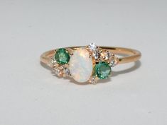 Opal Ring Cluster ring Opal engagement ring emerald | Etsy Green Opal Ring With Accent Stones For Wedding, Green Oval Opal Ring For Wedding, Fine Jewelry Green Opal Ring, Anniversary Green Opal Ring, Green Opal Ring For Anniversary, Opal And Emerald Engagement Ring, Elegant Green Opal Ring With Accent Stones, Vintage Opal Diamjnd Emerald Ring, Elegant Multi-stone Green Opal Ring