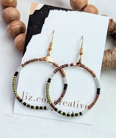 Green Brown and Black Metallic Glass Bead Boho Hoops // 1 1/2" diameter see more liz.cor.creative beaded hoop earrings here https://www.etsy.com/shop/lizcorcreative?ref=seller-platform-mcnav§ion_id=42427009 Adjustable Round Black Beaded Earrings, Brass Hoop Earrings, Casual Earrings, Fashion Beads, Nautical Jewelry, Casual Jewelry, Premier Designs Jewelry, Classic Earrings, Boho Green