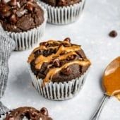 chocolate cupcakes with caramel drizzle on top and spoon next to them