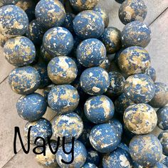 a bunch of blue and white balls sitting on top of each other next to the word navy