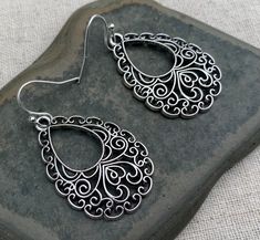 "Highly detailed and intricately designed boho filigree teardrop earrings. They are eye catching and versatile. Dress them up or down. These would be the perfect everyday earrings for any stylish lady. The earrings measure 1 1/4\" long by 1\" wide and are made from plated silver. They hang from simple silver ear wire hooks. Overall drop length is 1 3/8\". I have a matching necklace in my Etsy shop, if you would like the whole set. Here is a direct link Thanks for stopping by! Please take a momen Bohemian Sterling Silver Filigree Teardrop Earrings, Bohemian Teardrop Chandelier Earrings With Filigree, Bohemian Teardrop Filigree Chandelier Earrings, Bohemian Teardrop Earrings With Intricate Design For Gift, Bohemian Teardrop Earrings With Intricate Design As Gift, Bohemian Sterling Silver Teardrop Earrings With Intricate Design, Bohemian Teardrop Earrings With Intricate Design, Boho Silver Earrings, Boho Drop Earrings