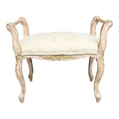 an old wooden bench with a cushion on it's back end and legs that have been carved into the seat