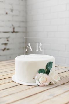 a white cake with the word air on it sitting on top of a wooden table