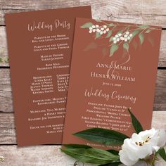 two wedding programs with white flowers on them