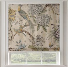 a window with a bird and flower pattern on the blind in front of an open window