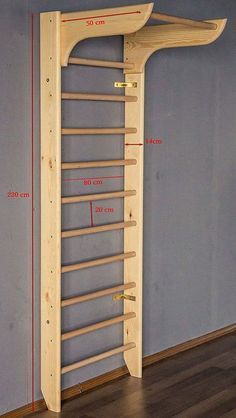 a large wooden rack in the corner of a room with measurements for it to be hung on