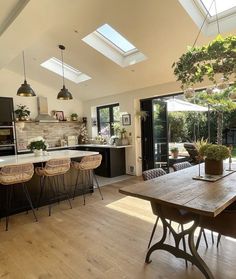 an open kitchen and dining room with skylights