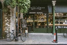 a bike is parked in front of a bakery