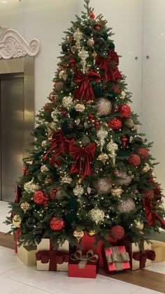 a decorated christmas tree with presents under it