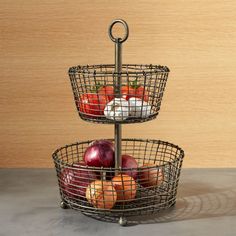 three tiered metal basket holding apples and cheese