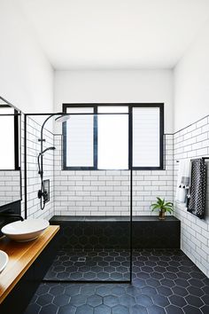 a black and white tiled bathroom with two sinks