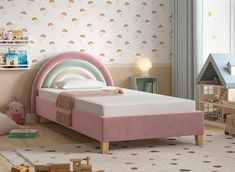 a child's bedroom with a pink bed and rainbow wallpaper on the walls