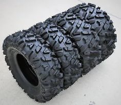 two atv tires are stacked on top of each other, one is black and the other is