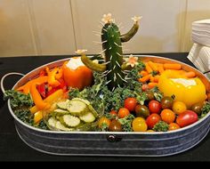 a metal container filled with lots of different types of vegetables