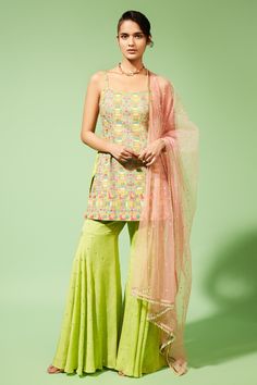 Green kurta with multicolor thread and mirror work embroidered pattern. Paired with flared hem sharara pants. Comes with sheer dupatta with bead tassels at hem.
Component: 3
Pattern: Embroidered
Type Of Work: Thread, Mirror work
Neckline: Square neck
Sleeve Type: Sleeveless
Fabric: Palazzo: Georgette, Kurta: Silk, Dupatta: Tulle
Color: Green,Pink
Other Details: 
Gathered detailing
Bead tasseled dupatta hem
Occasion: Mehendi and Haldi - Aza Fashions Gharara Pants, Palazzo Kurta, Georgette Kurta, Sharara Pants, Flared Palazzo, Short Kurta, Daily Paper, Sharara Set, Thread Embroidery