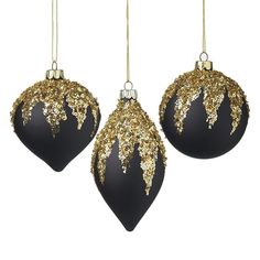 three black and gold christmas ornaments hanging from the top of each ornament on a white background