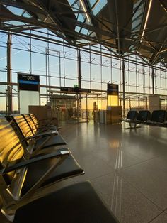 an empty airport terminal with lots of chairs