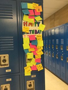 a locker with post it notes attached to the doors and hanging on the wall in a school hallway